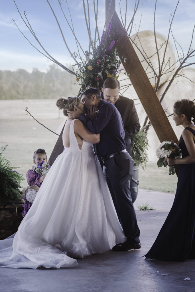 Image of a bride & groom's first kiss. 