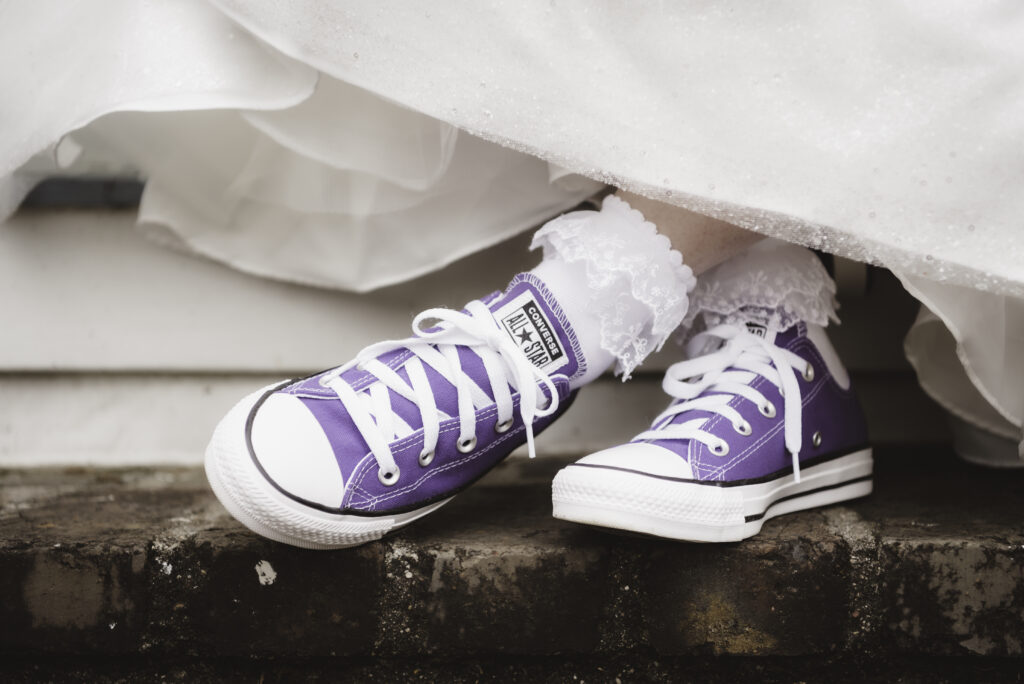 Purple converse tennis shoes and ruffle socks were the perfect choice for this bride. 